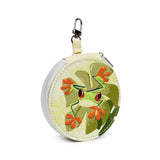 Angled view of a round manicure set case, featuring a vibrant green frog with red eyes on tropical leaves, a zip closure, and a silver-coloured clip.