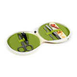 Angled view of an open 5-piece round manicure set, featuring a lime green fabric interior. The set includes black nail scissors and clippers, silver cuticle pusher and tweezers, and a nail file with a tropical frog design.