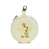 Front view of a round, cream-coloured manicure set case featuring a green tropical frog illustration, with a zip closure and a silver-coloured carabiner clip.