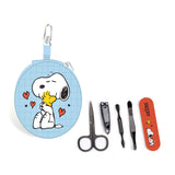 Front view of a light blue round zippered manicure set case, depicting Snoopy hugging Woodstock with red hearts, with a silver carabiner clip. Beside it are five loose manicure tools: black nail scissors, nail clippers, a cuticle pusher, tweezers, and an orange nail file with Snoopy and Woodstock.