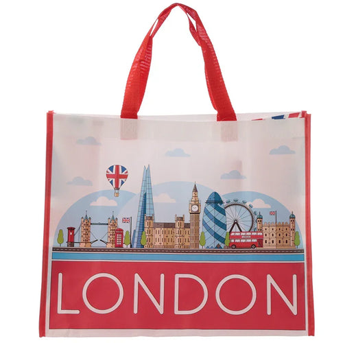 Front view of a white reusable shopping bag with red handles, depicting a colourful illustrated London icons skyline including Big Ben, Tower Bridge, London Eye, and a red double-decker bus. 'LONDON' is written in white on a red band at the base.