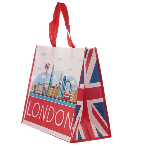 Angled view of a durable, reusable shopping bag with red handles. The bag's front displays a colourful illustration of London icons and 'LONDON' text, with a Union Jack flag design on the visible side.