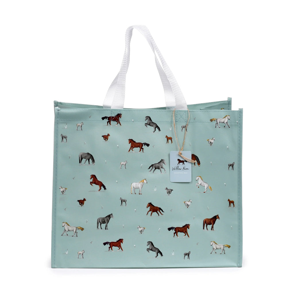 Front view of a light teal durable reusable shopping bag featuring a 'Willow Farm Horses' pattern with various coloured horses and foals. It has white woven handles and a rectangular 'Willow Farm' tag.