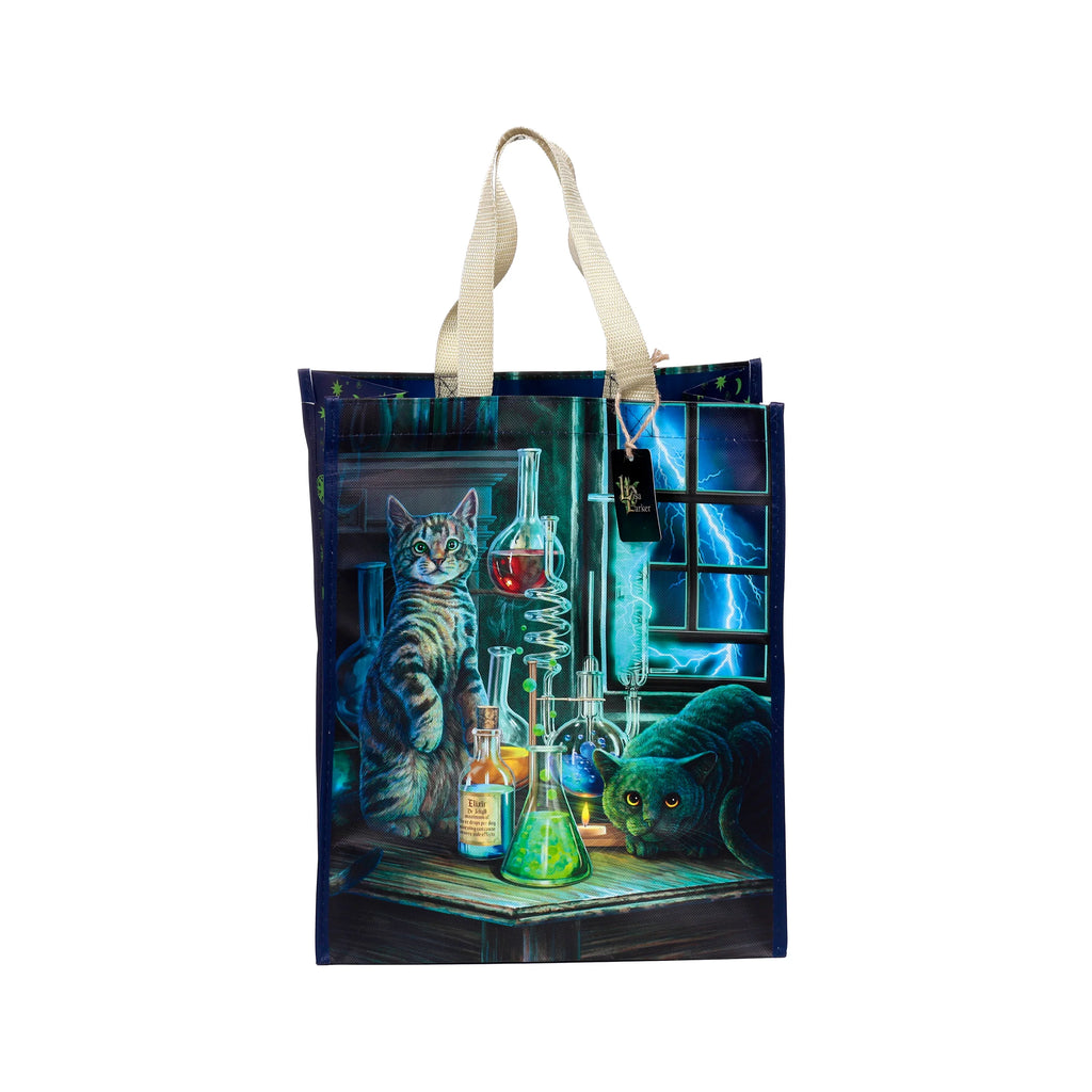 Front view of a durable reusable shopping bag with a Lisa Parker 'Jekyll and Hyde Cats' design, depicting a tabby cat and a dark cat in a science lab with beakers, colourful liquids, and an 'Elixir Dr Jekyll' bottle, against a stormy window with lightning. The bag has woven handles.