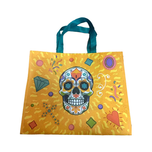 Front view of a vibrant yellow shopping tote bag with teal handles, featuring a detailed, colourful Day of the Dead sugar skull design surrounded by various motifs including hearts, diamonds, and crosses.
