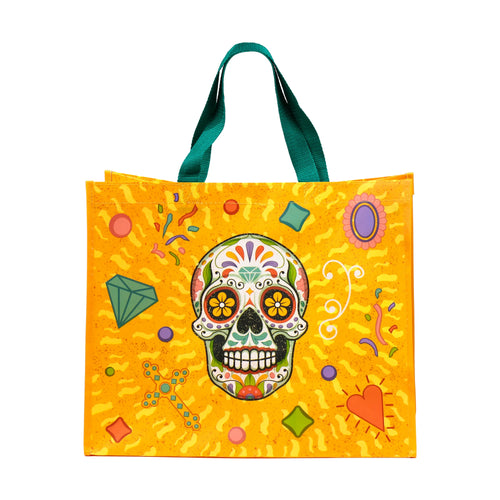 Front view of a colourful reusable shopping tote bag with green handles, featuring a vibrant Day of the Dead sugar skull design on a yellow background, surrounded by decorative motifs.