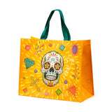 Front view of an orange durable reusable shopping bag, featuring a vibrant 'Day of the Dead' sugar skull design with intricate patterns and colourful accents, and green handles.