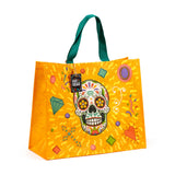 Front view of an orange durable reusable shopping bag, featuring a large, colourful Day of the Dead sugar skull, assorted festive patterns, green fabric handles, and a decorative 'Day of the Dead' product tag.