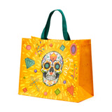 Front view of an orange reusable shopping tote bag with green handles, featuring a colourful Day of the Dead sugar skull design.