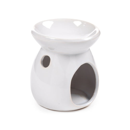 Angled view of a simple white glossy ceramic oil burner, showing the top bowl and a large arched opening in its base with a smaller circular vent.