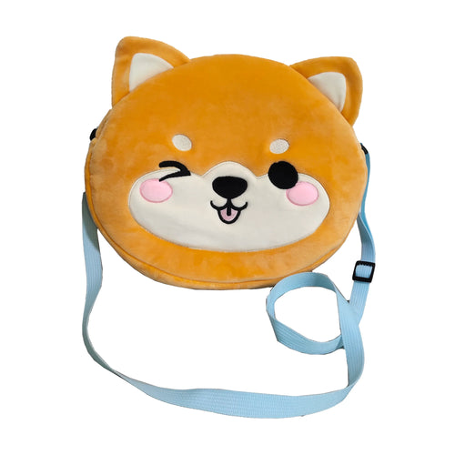 Front view of an orange and cream plush crossbody bag, shaped like a Shiba Inu dog's head, featuring a winking face with a pink tongue and an adjustable light blue strap.
