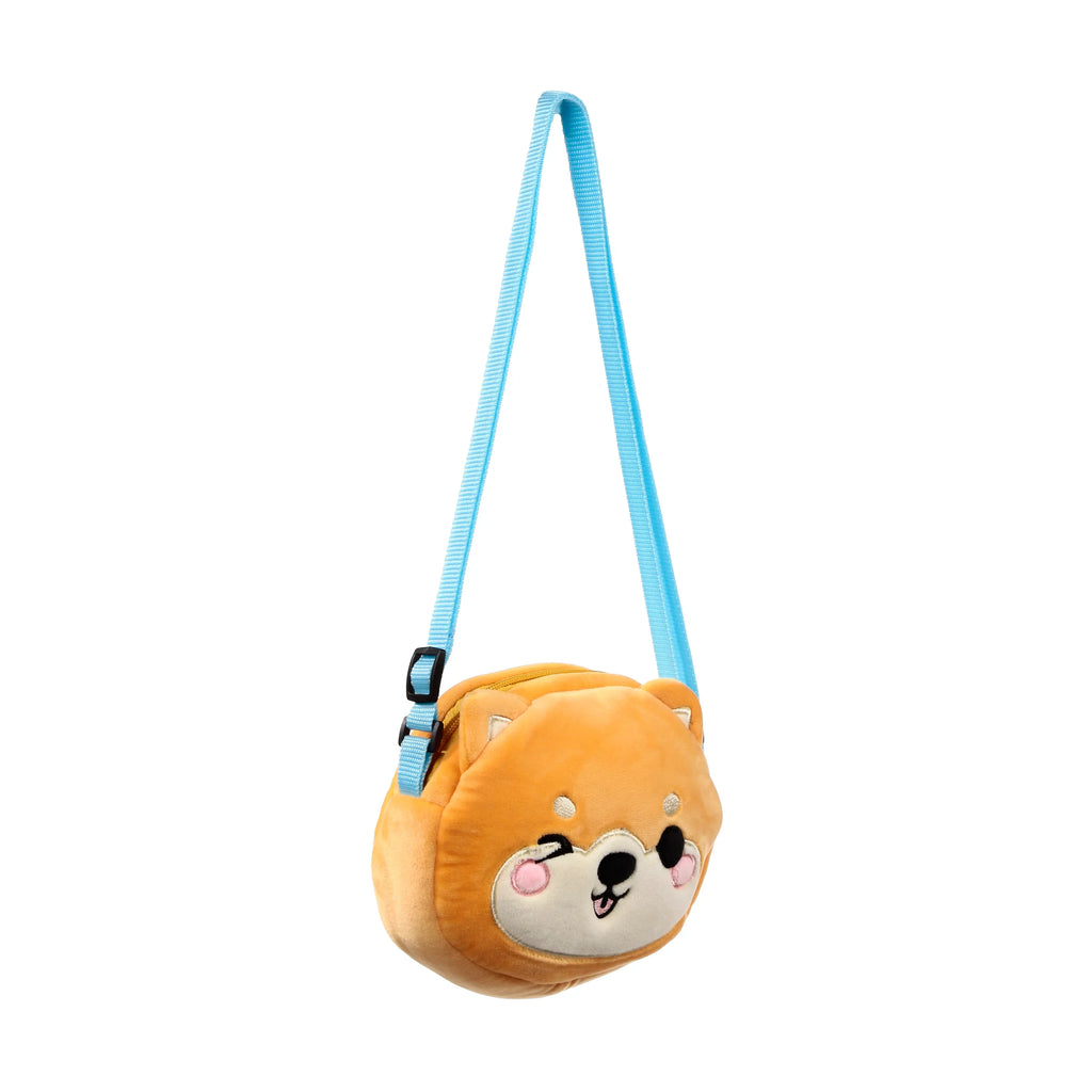 Front view of an orange plush Shiba Inu crossbody bag with a winking face and a light blue adjustable strap.