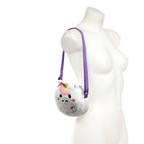 Front view of a plush white unicorn cross-body bag featuring a golden horn, rainbow mane, and purple strap, displayed on a mannequin.