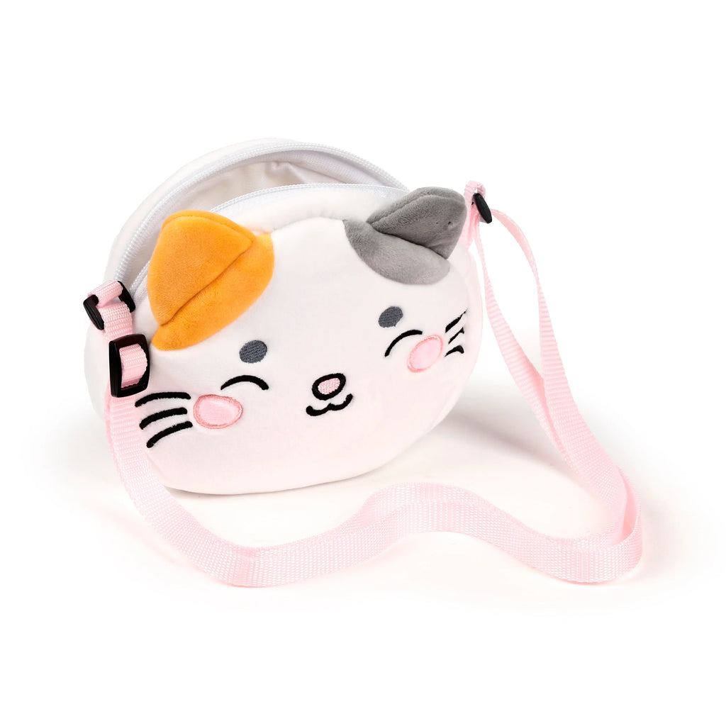Angled view of a white plush cat-shaped crossbody bag with orange and grey ears, embroidered black and pink facial features, and a light pink strap.