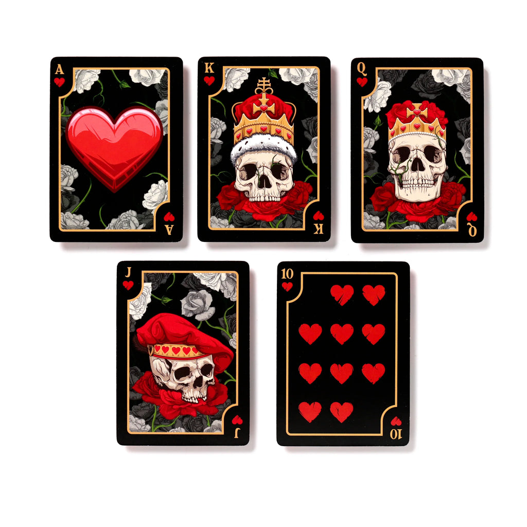 Overhead view of five black Skulls and Roses playing cards from the Hearts suit, laid out on a white background. The visible cards include the Ace with a large red heart, the King, Queen, and Jack each depicting a skull with ornate headwear and red roses, and the Ten of Hearts displaying red heart pips. All cards feature grey and black roses in the background.