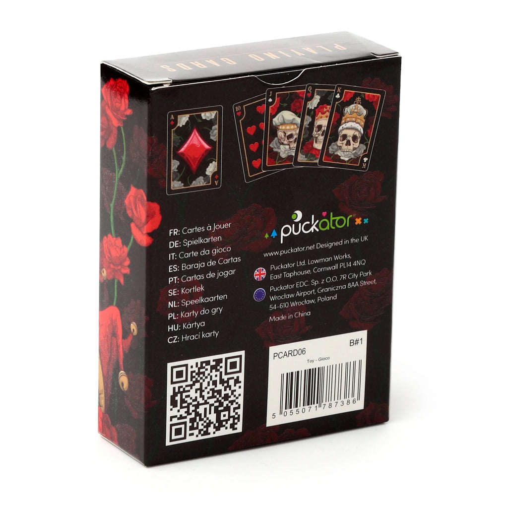 Angled view of a black standard playing cards box, featuring skull and red rose artwork with custom skull-faced card designs visible on its prominent panel.