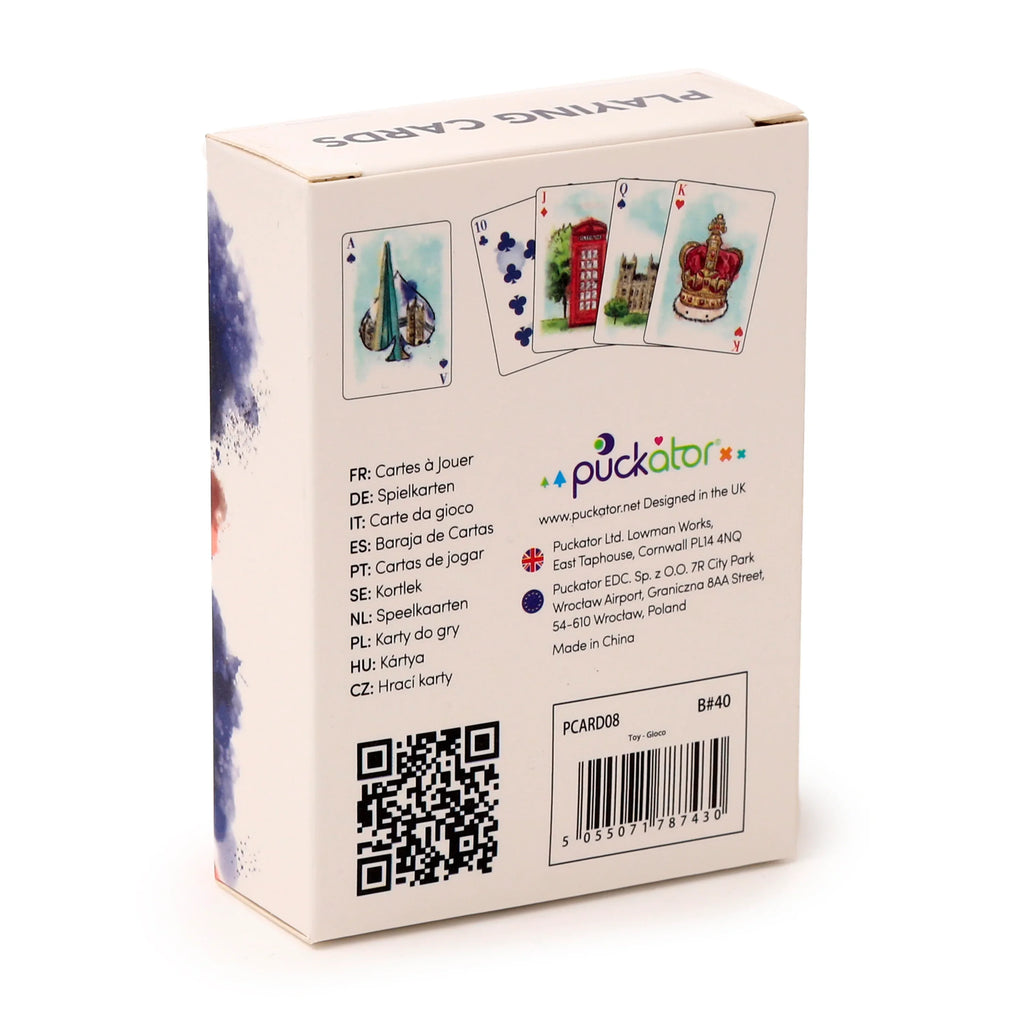 Angled view of a white playing card box, showcasing London-themed illustrations on its main side. These include an Ace of Spades with a building resembling Big Ben, a Ten of Clubs with a red telephone box, and a King of Hearts with a crown. The box features multilingual product information, a QR code, a barcode, and a blue watercolour design on its left side, with 'PLAYING CARDS' printed on the top.