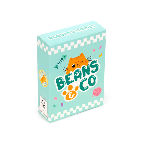 Angled view of a light blue standard deck of playing cards box. The front depicts a playful orange cat illustration, 'Beans & Co' text, a paw print, fish skeleton, and pink yarn. 'Playing cards' is printed on the box top.