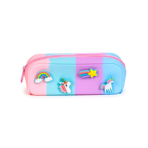 Angled view of a silicone pencil case in ombre pink, blue, and purple, featuring colourful unicorn, rainbow, and shooting star charms on its front, with a pink zip closure.