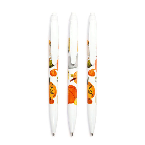 Three white pens from a 3 piece pen set, decorated with a colourful autumn harvest design of pumpkins, leaves, and vines, displayed from above.