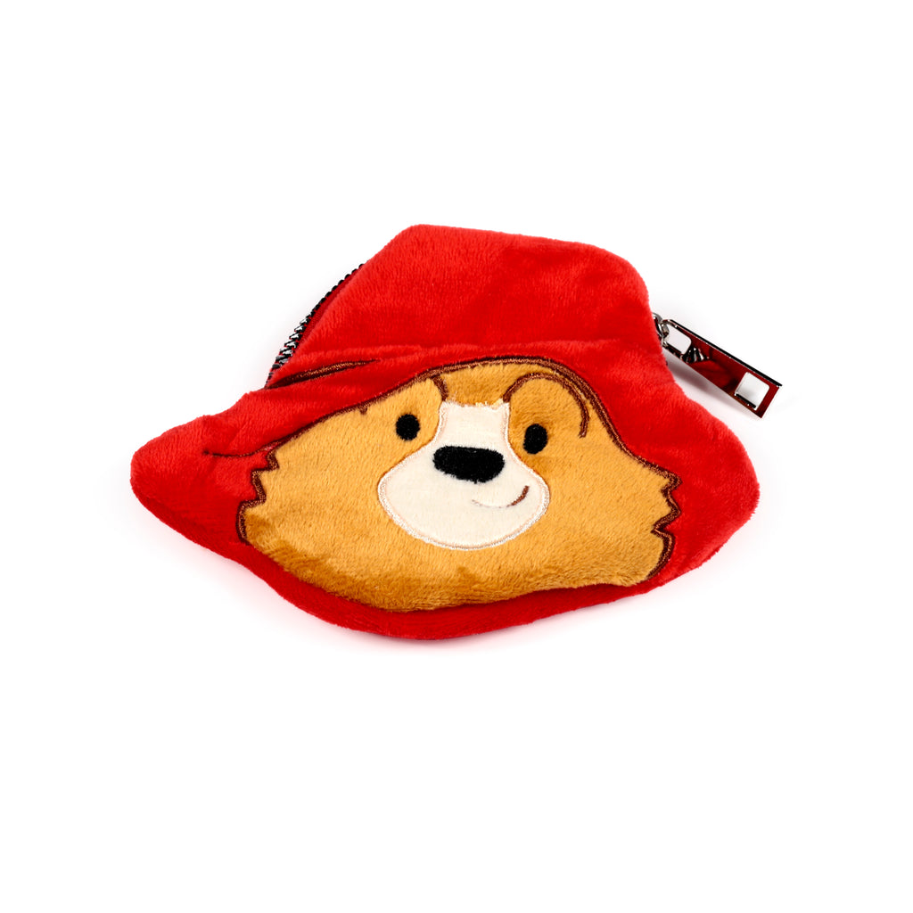 Front view of a plush Paddington Bear change purse, featuring his red hat, brown face with embroidered details, and a silver-coloured zipper pull.