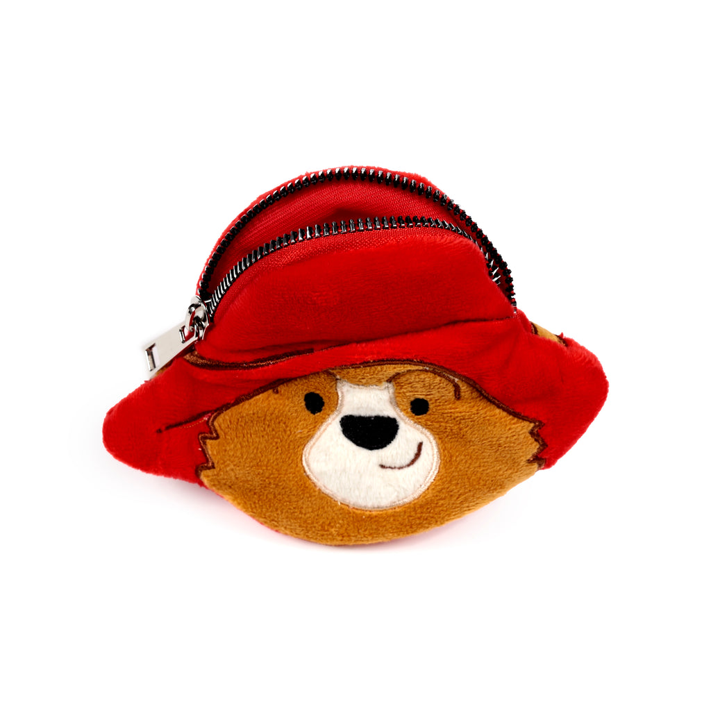 Front view of a plush change purse depicting a brown bear's face wearing a red hat, with an open black zip revealing the red interior.
