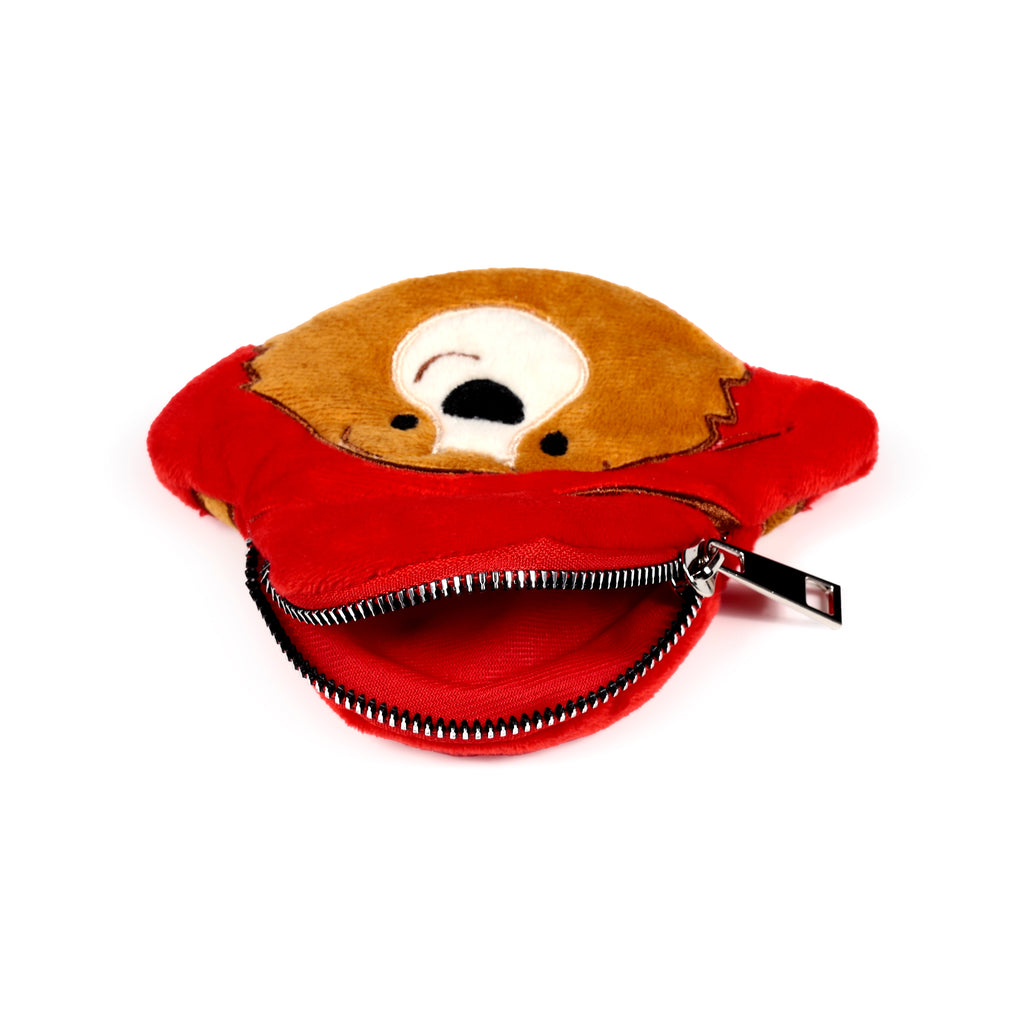 Angled view of a plush Paddington Bear change purse, depicting its brown bear head and red hat design. The red zip is open, revealing the purse's red interior and a silver-coloured zipper pull.