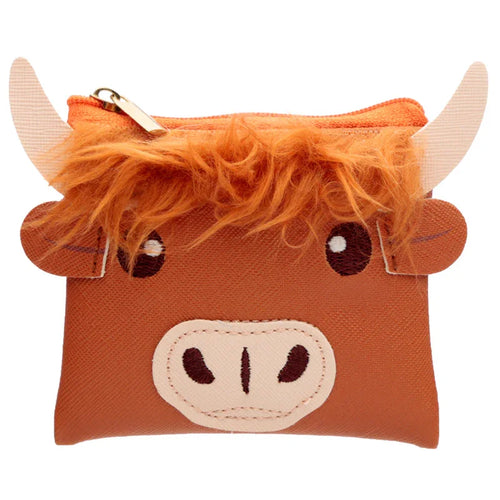 Front view of a brown PVC Highland Coo cow purse, detailed with orange fluffy fringe, appliquéd eyes and snout, beige horns, and a gold zipper.