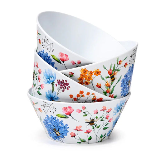 Angled view of a stack of four white picnic bowls, decorated with a vibrant floral and bee pattern in blue, orange, and pink.