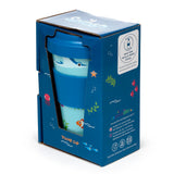Front and side view of a recycled RPET travel mug in its blue cardboard box, featuring sealife illustrations including a shark, clownfish, starfish, and jellyfish. The travel cup has a light blue body with a dark blue lid and silicone band, visible through the box's cutout.