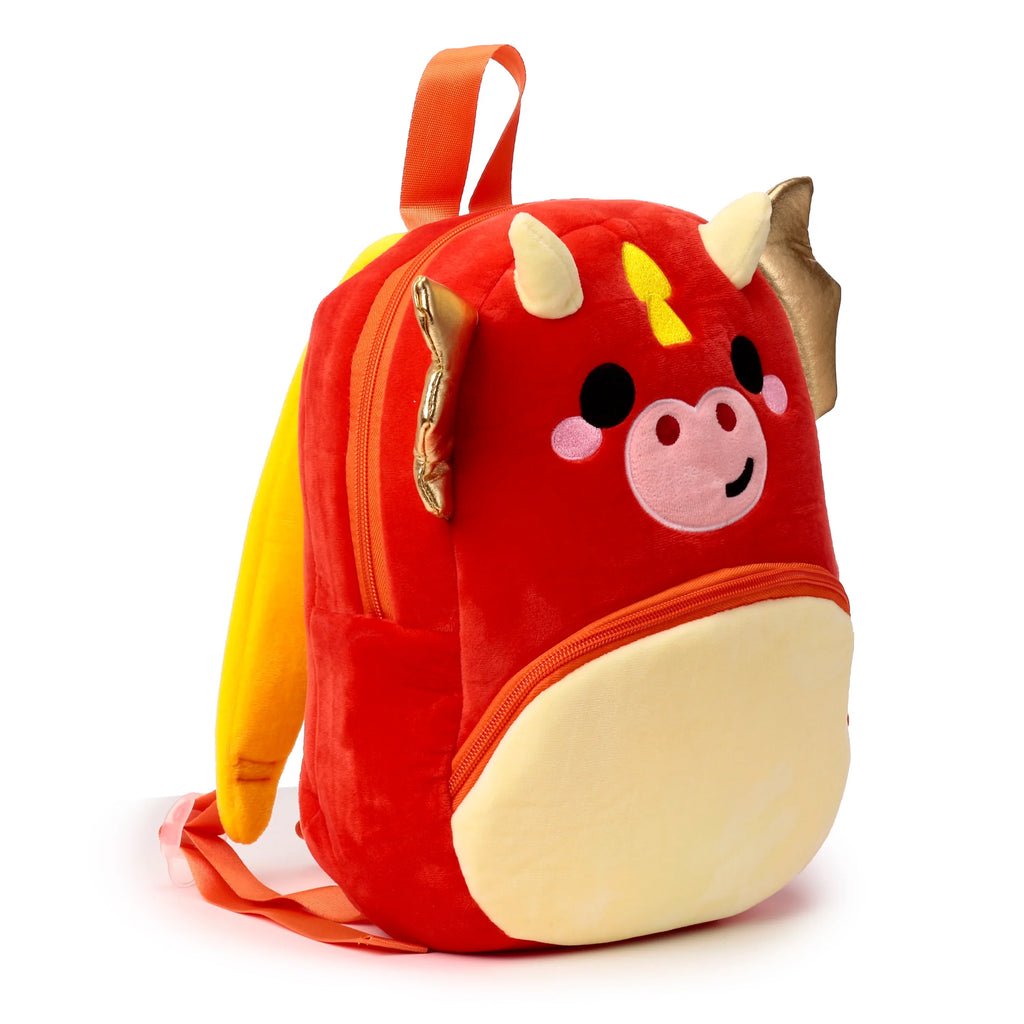 Front view of a red and yellow plush kids school backpack designed as a dragon character, featuring stitched eyes, nose, mouth, horns, and gold wings, displayed on a white background.