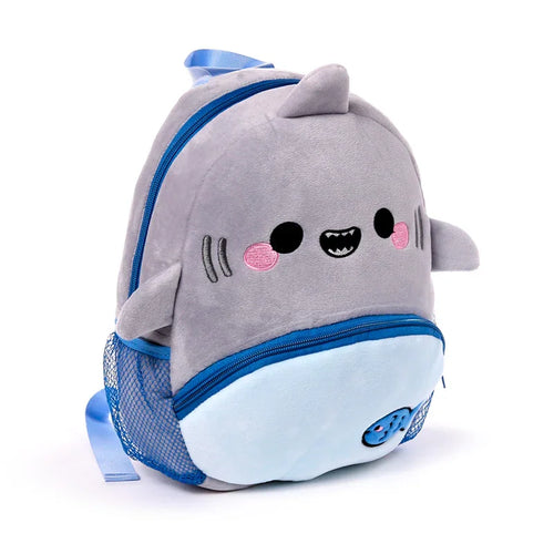 Front angled view of a grey and light blue plush kids shark school backpack, featuring a cartoon shark face, blue zippers, and a mesh side pocket, on a white background.