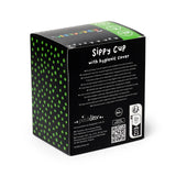 Angled view of a black sippy cup packaging box with green polka dots, displaying 'Sippy Cup with hygienic cover' text, a 'Dinosauria Jr' graphic, and a 6m+ age icon.