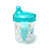Front view of a clear plastic sippy cup with a teal lid and handle, featuring unicorn and rainbow patterns.