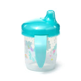 Angled view of a clear reusable sippy cup with a teal spout lid and matching handle. The cup is adorned with a vibrant unicorn, rainbow, cloud, and star pattern.