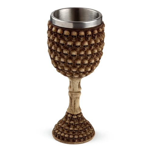 Angled view of a decorative Gothic goblet with a metallic inner cup. The outer surface of the cup and base are covered in numerous light brown skull motifs, and the stem has a bone-effect design.