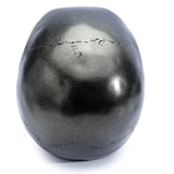 Metallic black skull decoration, top-down angled view showing its speckled metallic finish and prominent cranial sutures.