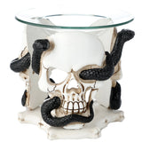 White skull and black serpent resin oil and wax burner with a clear glass dish, showing the central skull.