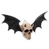 Front view of a Gothic wall plaque, a beige devil bat skull with small black horns, pointed ears, and large black wings, including a metal hanger.