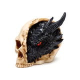 Black dragon ornament with striking red eyes, textured scales and horns, set within a light bone-coloured skull figurine.