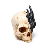 Angled view of a figurine featuring a textured black dragon emerging from a cracked beige skull.