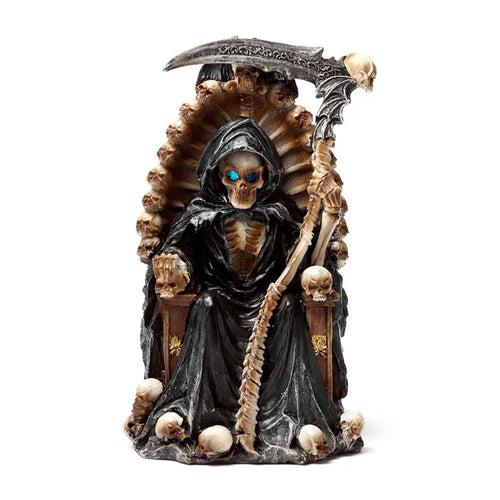 Front view of a decorative Reaper ornament depicting a hooded skeleton with glowing blue eyes, sitting on a throne made of skulls and holding a scythe.