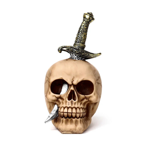 Front view of a decorative skull ornament, pierced by a sword through the top, with a blade emerging from its mouth.