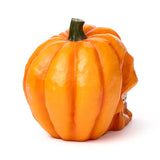 Angled view of an orange pumpkin skull decorative ornament, featuring a ribbed texture, green stem, and the skull's jaw visible on the right.