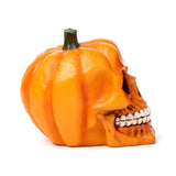 Side view of an orange pumpkin skull decorative ornament, featuring ribbed pumpkin details, a green stem, and visible skull teeth.