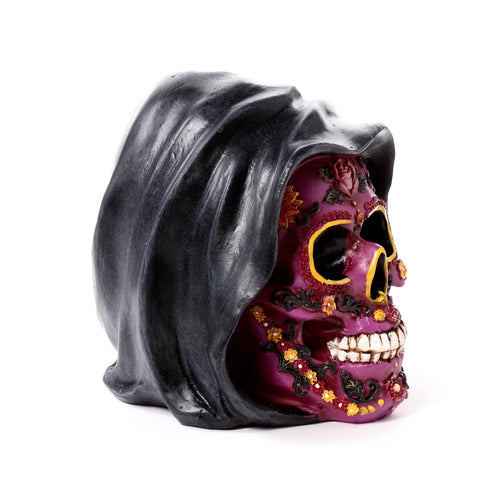 Angled view of a decorative Day of the Dead purple skull ornament with a black hood, intricately decorated with red roses, yellow flowers, black swirls, and white teeth.