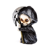 Decorative Reaper mini skull figurine, angled to show its black hooded cloak, skeletal hands, and silver scythe.