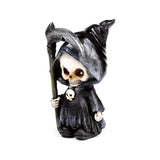 Front view of a decorative reaper ornament, depicting a skull-faced figure in a black hooded cloak, holding a scythe and featuring a small skull detail on its chest.
