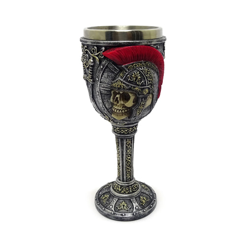 Front view of a decorative goblet featuring a skull in a Roman soldier's helmet with a red plume, adorned with silver and gold-coloured intricate patterns.