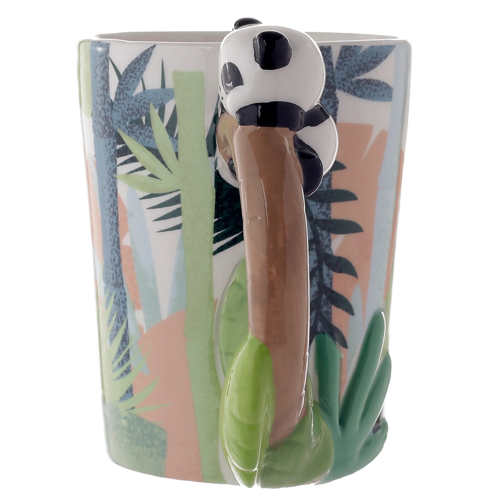 Angled view of a ceramic panda mug, featuring a shaped handle depicting a black and white panda climbing a brown tree trunk, with a colourful abstract jungle pattern on the mug's body.